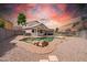 Backyard oasis featuring a uniquely shaped pool, decorative rocks, and low maintenance landscaping at 910 S Crossbow Ct, Chandler, AZ 85225