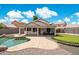 Wide angle of the backyard featuring a putting green, pool, and covered patio at 910 S Crossbow Ct, Chandler, AZ 85225