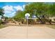 Outdoor basketball court surrounded by landscaping and trees, offering a place for recreational activities at 910 S Crossbow Ct, Chandler, AZ 85225