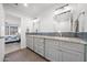 Bathroom with double vanity, granite counters, and access to the bedroom at 910 S Crossbow Ct, Chandler, AZ 85225