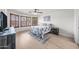 Comfortable bedroom with light wood floors, decorative shutters, and a cozy rug at 910 S Crossbow Ct, Chandler, AZ 85225
