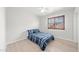 Bright bedroom with laminate flooring, shutters on the window, and striped bedding on the bed at 910 S Crossbow Ct, Chandler, AZ 85225