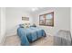Bright bedroom with laminate flooring, shutters on the window, and blue and yellow bedding on the bed at 910 S Crossbow Ct, Chandler, AZ 85225