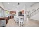 Open kitchen with stainless appliances, an island with barstool seating, and a view of the staircase at 910 S Crossbow Ct, Chandler, AZ 85225
