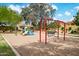 Community playground with swings, slides, and climbing structure in a landscaped area at 910 S Crossbow Ct, Chandler, AZ 85225