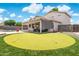 Backyard putting green with view of covered patio, perfect for outdoor activities at 910 S Crossbow Ct, Chandler, AZ 85225