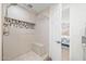 Walk-in shower with tile surround, shower bench, and decorative mosaic tile accents in updated bathroom at 910 S Crossbow Ct, Chandler, AZ 85225