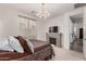Bright bedroom with an ornate chandelier, fireplace, and a doorway at 9312 E Spiral Ave, Mesa, AZ 85212