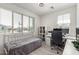 Bright bedroom with natural light, featuring a built-in desk and shelving at 9312 E Spiral Ave, Mesa, AZ 85212
