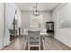 Well-lit dining room with modern light fixture and easy access to the outdoor patio at 9312 E Spiral Ave, Mesa, AZ 85212