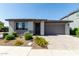 Charming single-story home featuring a two-car garage and beautifully landscaped front yard at 9312 E Spiral Ave, Mesa, AZ 85212