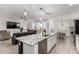 Open concept design featuring a kitchen island and view to the modern living and dining spaces at 9312 E Spiral Ave, Mesa, AZ 85212