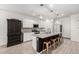 Modern kitchen with granite countertops, stainless steel appliances, and island with bar seating at 9312 E Spiral Ave, Mesa, AZ 85212