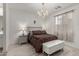 Comfortable main bedroom featuring decorative chandelier lighting, warm textiles, and ample natural light at 9312 E Spiral Ave, Mesa, AZ 85212