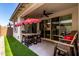 Inviting outdoor patio featuring a dining set under a shaded umbrella at 9312 E Spiral Ave, Mesa, AZ 85212
