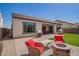 Inviting backyard features artificial grass, a covered patio, a grill, fire pit, and a playhouse at 9678 W Patrick Ln, Peoria, AZ 85383
