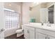 The well lit bathroom has a shower-tub combo, vinyl floors, and a single sink vanity at 9678 W Patrick Ln, Peoria, AZ 85383