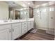 Bright bathroom with dual vanities, a glass-enclosed shower, and modern finishes for a luxurious feel at 9678 W Patrick Ln, Peoria, AZ 85383