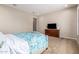 Comfortable bedroom with soft carpet and a TV for a relaxing and private retreat at 9678 W Patrick Ln, Peoria, AZ 85383
