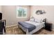 Relaxing bedroom featuring a queen bed, shuttered window, and decorative wall art for a calm atmosphere at 9678 W Patrick Ln, Peoria, AZ 85383