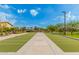 Inviting bocce ball court featuring artificial turf, concrete lanes, and mature landscaping for outdoor community fun at 9678 W Patrick Ln, Peoria, AZ 85383