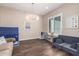 The bonus room has vinyl floors, bright lighting, and cozy furniture at 9678 W Patrick Ln, Peoria, AZ 85383