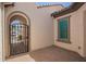 Gated courtyard featuring a paver floor and an arched entry way to the garage at 9678 W Patrick Ln, Peoria, AZ 85383