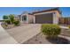 Attractive single-story home with a tile roof, green shutters, paver driveway, and manicured landscaping at 9678 W Patrick Ln, Peoria, AZ 85383