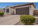Charming single-story home featuring a tile roof, a paver driveway, and a convenient two-car garage at 9678 W Patrick Ln, Peoria, AZ 85383