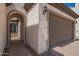 Arched entry way into a two car garage and a gated courtyard entrance at 9678 W Patrick Ln, Peoria, AZ 85383
