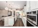 A spacious kitchen boasts stainless steel appliances, a large island, and ample countertop space for cooking at 9678 W Patrick Ln, Peoria, AZ 85383