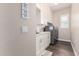 A functional laundry room with modern appliances, white cabinetry, and ample counter space at 9678 W Patrick Ln, Peoria, AZ 85383