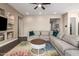 Inviting living room with a comfortable sectional, built-in shelving, and neutral color scheme for a cozy atmosphere at 9678 W Patrick Ln, Peoria, AZ 85383