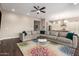 Open-concept living room with a large sectional, colorful rug, and views into the kitchen, perfect for entertaining at 9678 W Patrick Ln, Peoria, AZ 85383