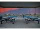 Pickle ball courts under a shade structure at dusk with picnic benches at 9678 W Patrick Ln, Peoria, AZ 85383