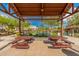 Community amenity featuring a pickleball court with picnic tables beneath a shady pergola at 9678 W Patrick Ln, Peoria, AZ 85383