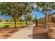 A well-maintained path winds through a lush park area with trees and greenery for recreational enjoyment at 9678 W Patrick Ln, Peoria, AZ 85383
