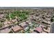 Neighborhood aerial view with houses, pools, solar panels, and green spaces showcasing a vibrant community with many amenities at 10359 E Los Lagos Vista Ave, Mesa, AZ 85209