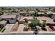 An aerial view of a single-Gathering home featuring a desert-landscaped front yard, mature trees, and a paved driveway at 10359 E Los Lagos Vista Ave, Mesa, AZ 85209