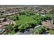An aerial view of a greenbelt and park area within a well-manicured community, complete with mature trees and neighborhood access at 10359 E Los Lagos Vista Ave, Mesa, AZ 85209