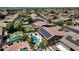 Aerial view of home with backyard featuring a pool, patio furniture, a grassy area, and lush, mature landscaping at 10359 E Los Lagos Vista Ave, Mesa, AZ 85209