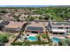 Aerial shot of a home with a private backyard featuring a pool, patio, and solar panels, perfect for outdoor living at 10359 E Los Lagos Vista Ave, Mesa, AZ 85209