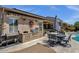 Backyard featuring an outdoor grill, patio seating, outdoor fan, and low-maintenance desert landscaping at 10359 E Los Lagos Vista Ave, Mesa, AZ 85209