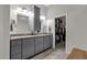 Bathroom showcasing double sinks, granite countertop, storage cabinet, and walk-in closet at 10359 E Los Lagos Vista Ave, Mesa, AZ 85209