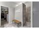 Bathroom featuring walk-in shower, walk-in closet, bench, and gray tile flooring at 10359 E Los Lagos Vista Ave, Mesa, AZ 85209