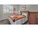 Comfortable bedroom features natural light, a wooden headboard and colorful quilt at 10359 E Los Lagos Vista Ave, Mesa, AZ 85209