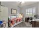 Cozy bedroom featuring a daybed, desk area, and neutral color scheme at 10359 E Los Lagos Vista Ave, Mesa, AZ 85209