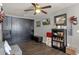 Bonus room featuring Murphy bed, wood flooring, and shelving with decorative items at 10359 E Los Lagos Vista Ave, Mesa, AZ 85209