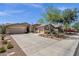 Charming exterior features a three-car garage, desert landscaping, and an American flag at 10359 E Los Lagos Vista Ave, Mesa, AZ 85209
