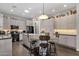 Modern kitchen with stainless steel appliances, large island with seating, and stylish light wood cabinets at 10359 E Los Lagos Vista Ave, Mesa, AZ 85209